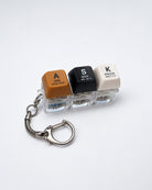 ASK SEEK KNOCK light-up keycap keychain with three coloured keys and silver clasp on a white background
