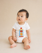 Baby wearing a white Beloved Juice Christian romper with colourful drink pouch design