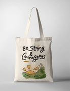 Cream canvas tote bag featuring “Be Strong & Courageous – Joshua 1:9” with a cute illustrated hill and child design, Christian inspirational gift.