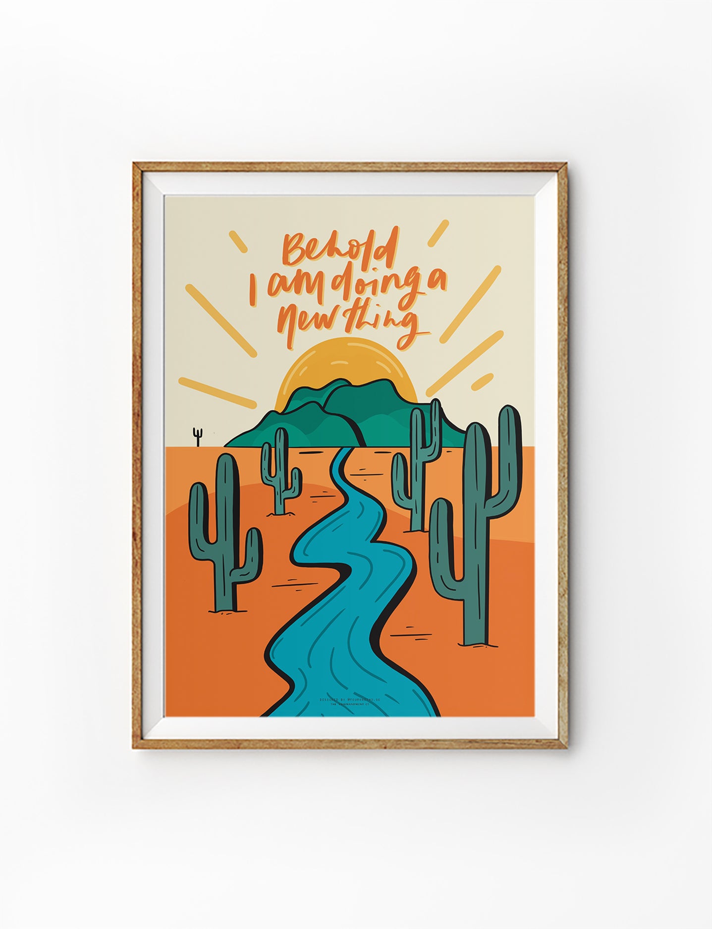 Framed Christian wall art illustration of a desert landscape with cacti, a flowing river, and the words “Behold, I am doing a new thing,” inspired by Isaiah 43:19.