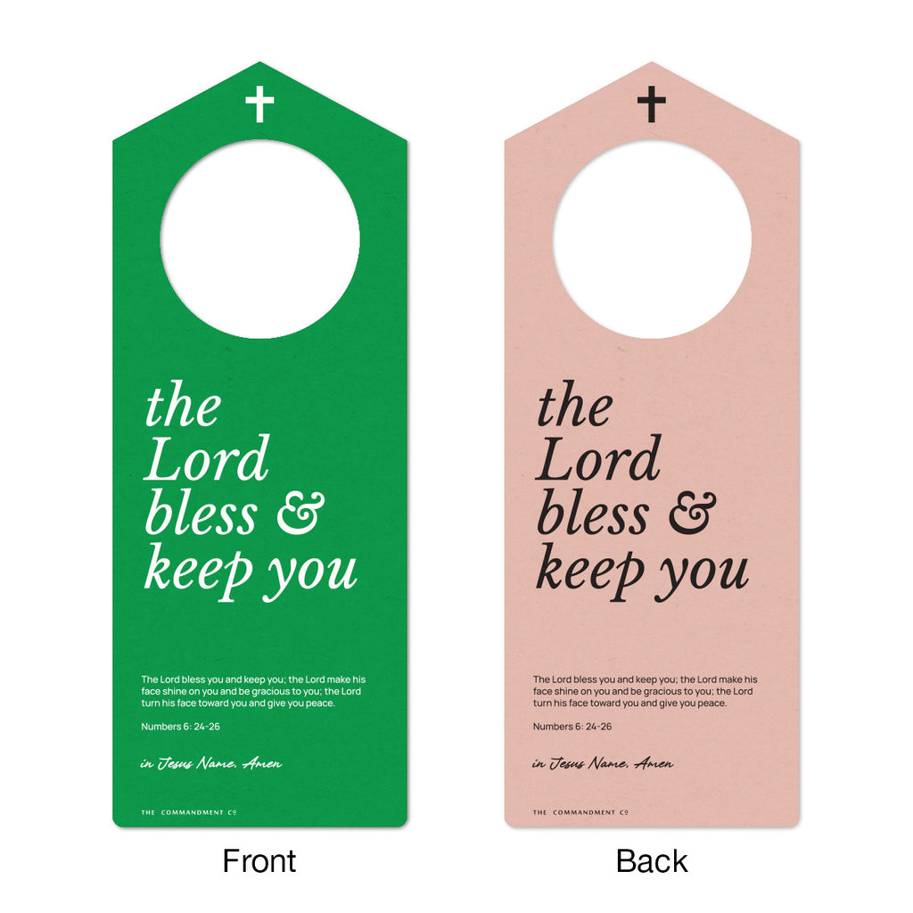 Front and back view of a Christian door hanger with the text 'The Lord bless and keep you,' featuring Numbers 6:24-26 Bible verse in green and pink color schemes.