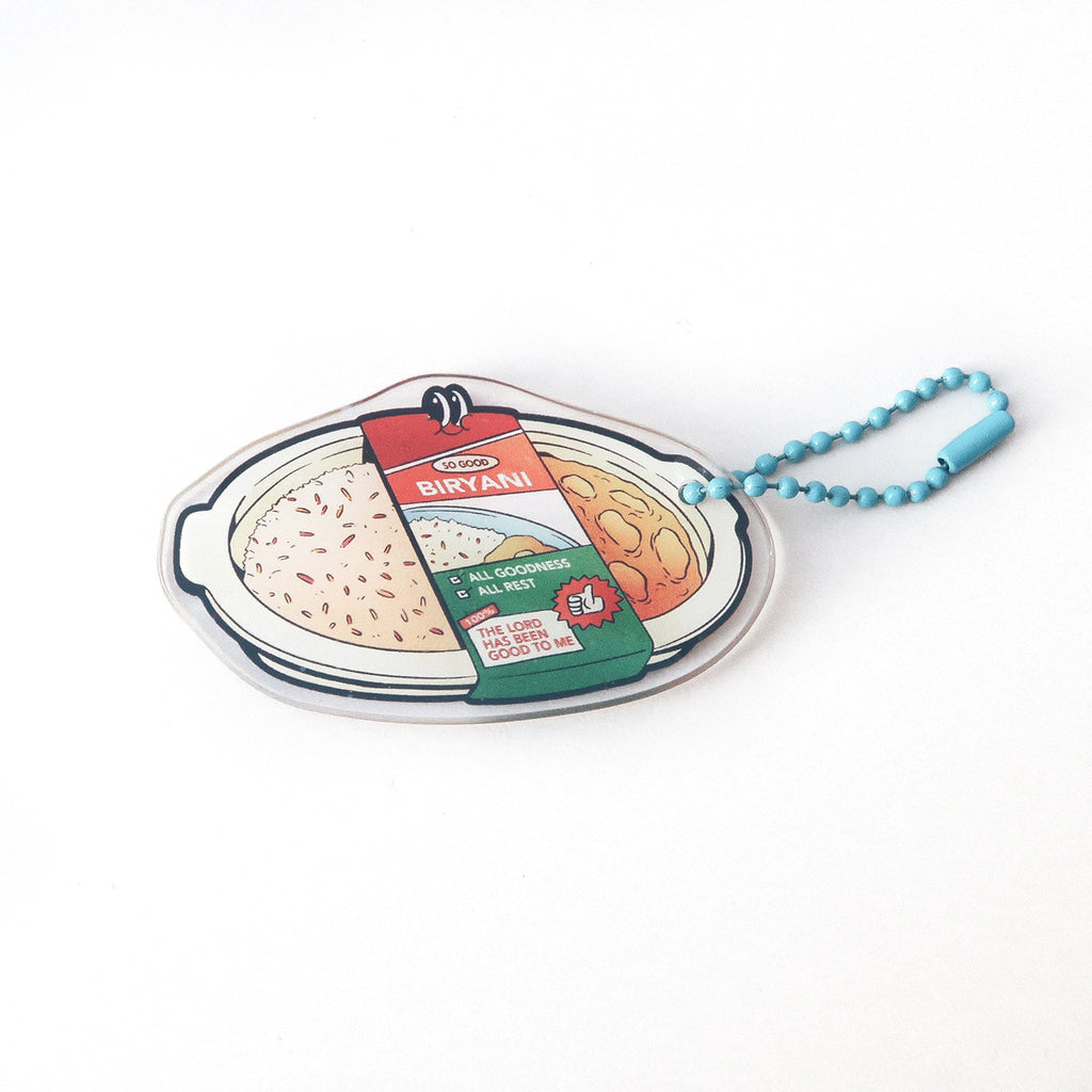 Christian keychain shaped like a biryani plate with the text 'The Lord Has Been Good to Me,' combining faith and food for a meaningful and cheerful accessory.