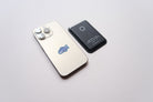 Black Leather Magsafe Wallet placed next to a mobile phone