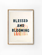 Blessed and Blooming Christian poster with floral artwork in a wooden frame