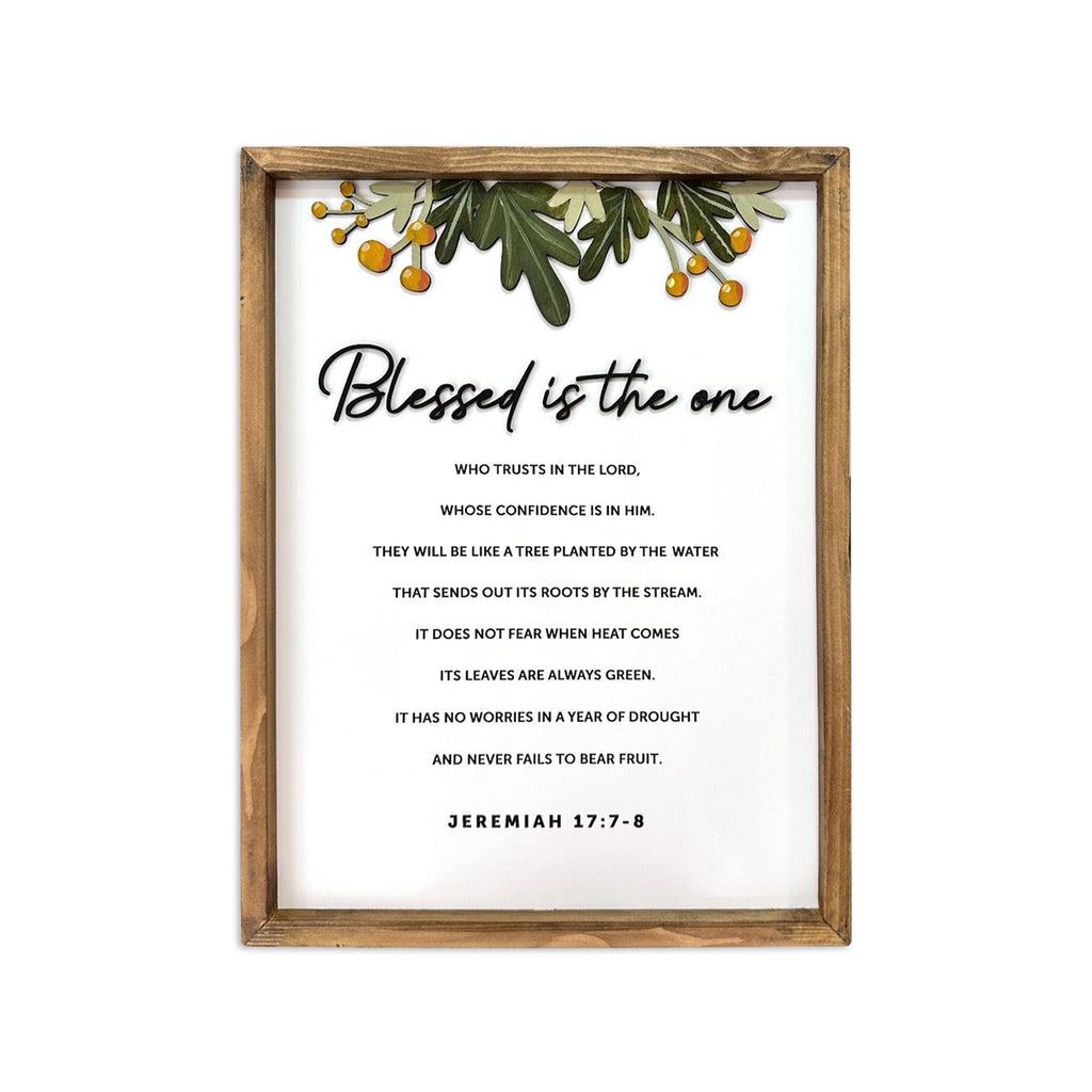 Framed Bible verse wall art with the phrase 'Blessed is the one' from Jeremiah 17:7-8, featuring greenery and orange berry decorations.