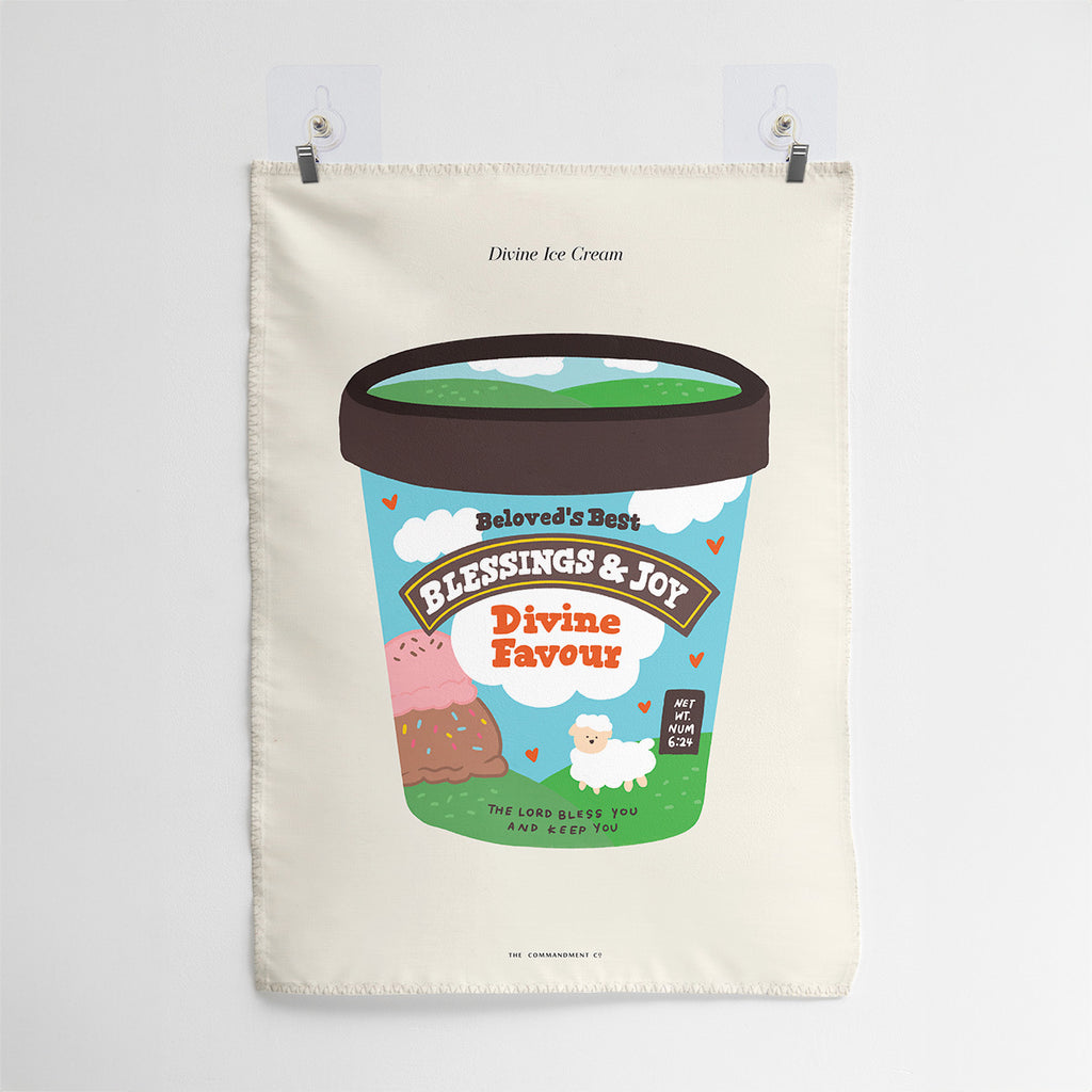 Wall tapestry featuring an ice cream tub design labeled 'Blessings & Joy Divine Favour' with scripture reference Numbers 6:24, along with a lamb and colorful illustrations.