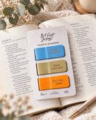But First Jesus magnetic bookmarks in blue, olive and orange displayed on an open Bible in a warm lifestyle setting.