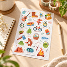 Camp Everyday Christian sticker sheet styled on a bright wooden desk with notebook, pen, washi tape and warm natural light