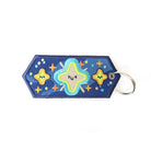 Inspirational keychain with colorful star embroidery on a blue background.