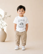 Child wearing the white Dear God kids T-shirt with notebook-style Jesus gratitude design
