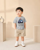 Child wearing the grey Policeman to the Rescue kids T-shirt with police car design