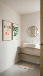 Choose Joy Christian poster styled beside the separately sold Covered in Grace poster in a bright minimalist bathroom
