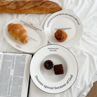 Inspirational Christian breakfast scene with bread, pastries, and scripture plates featuring uplifting messages like "Dreams sprout because of God," reflecting faith and simple happiness.