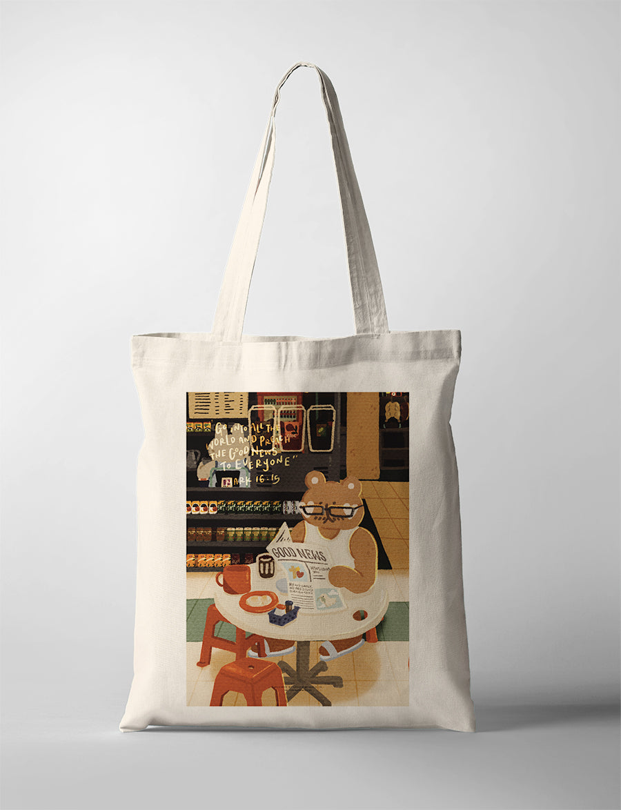 Natural canvas Christian tote bag featuring a bear reading the Good News in a convenience store with Mark 16:15.