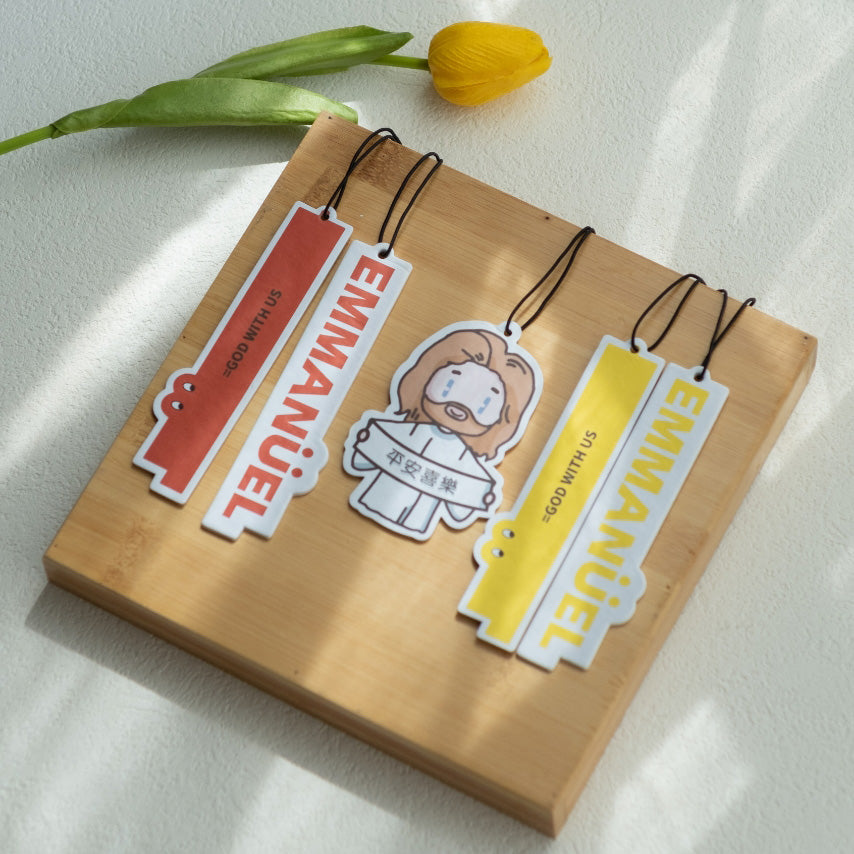 Faith-based air fresheners featuring 'Emmanuel God With Us' and 'Peace & Joy' in vibrant colors