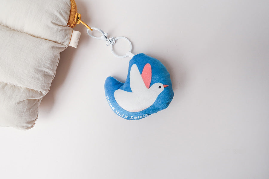 Dove-shaped plush keychain with 'Come Holy Spirit' text, offering a soft reminder of peace and guidance for faithful journeys.