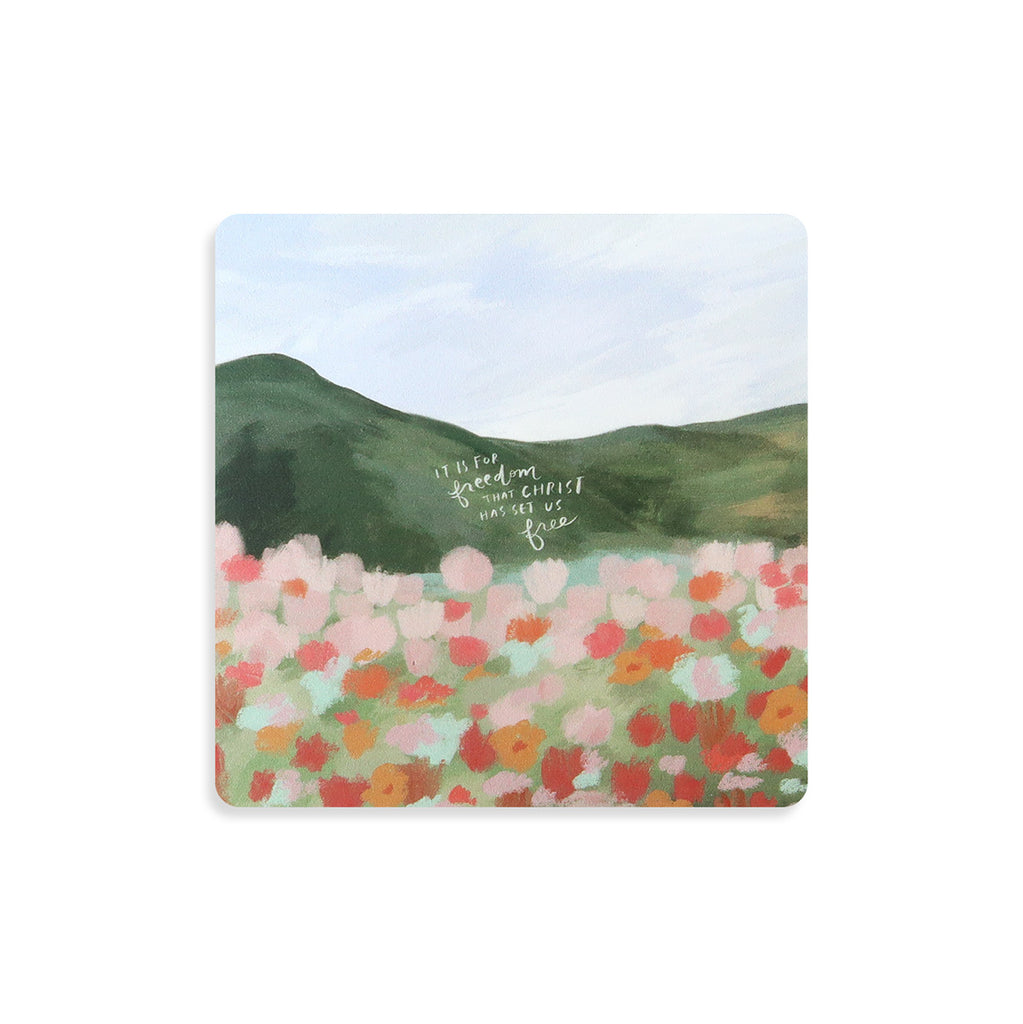 Christian-themed coaster with a floral field design and the quote 'It is for freedom that Christ has set us free,' perfect for faith-inspired home decor.