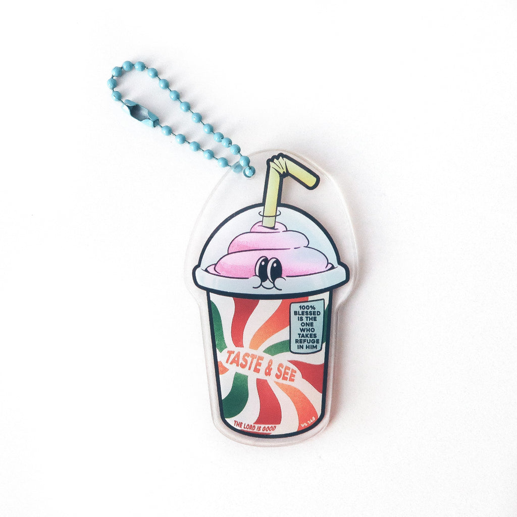 Christian keychain designed as a colorful cup with the text 'Taste & See, The Lord is Good,' featuring Psalm 34:8 and emphasizing blessedness and refuge in God.