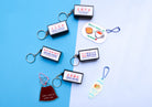 Christian lightbox keychain collection glowing in a dark display