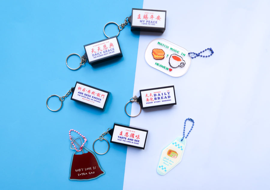 Christian lightbox keychain collection glowing in a dark display