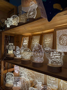 The Commandment Co Christian night lights displayed together on wooden shelves