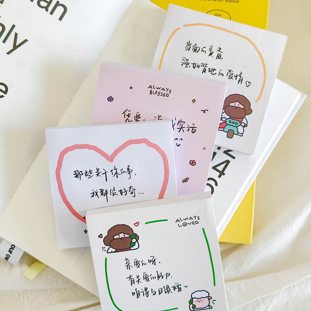 A collection of four Christian-themed sticky notes with designs including Jesus and a sheep, heart motifs, and Chinese text, laid out on books, perfect for faith-inspired gifts and stationery