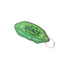Backside of the green 'Peas Be With You' keychain with motivational text.
