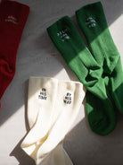 Faith-inspired socks set in red, green, and ivory with embroidery reading “All Things New,” “Always Grateful,” “In His Time,” and “By His Way” — a Christian gift idea.