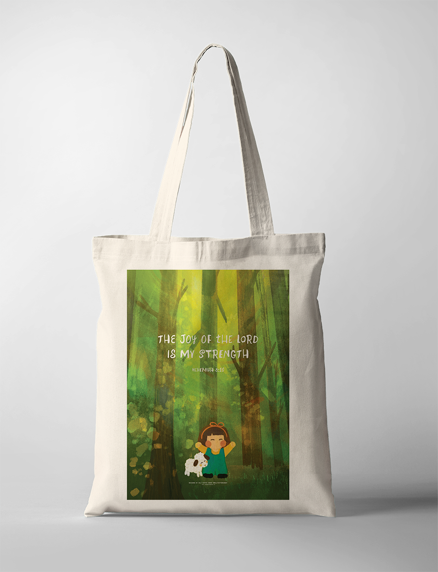 Christian tote bag featuring a joyful girl with a sheep in a lush green forest, printed with the uplifting Bible verse "The joy of the Lord is my strength" from Nehemiah 8:10, inspiring simple happiness and faith.