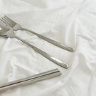 Stainless steel cutlery set including a spoon, fork, and chopsticks in a canvas pouch with the message "God loves you" and a Bible verse from Jeremiah 31:3.