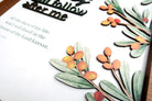 Close-up view of a layered wooden board poster featuring vibrant details of orange berries and green leaves. The handcrafted design adds depth and texture, creating an elegant decorative element.