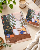 Comfort in Winter Christian jigsaw puzzle assembled beside its matching box, showing a cosy Christmas scene with Jesus and a companion.