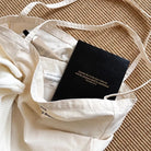 Black Jin Cha God Commit Thy Works A5 notebook with gold foil Proverbs 16:3 cover styled inside a tote bag