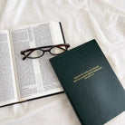 Green Jin Cha God Commit Thy Works A5 notebook with gold foil Proverbs 16:3 cover beside an open Bible