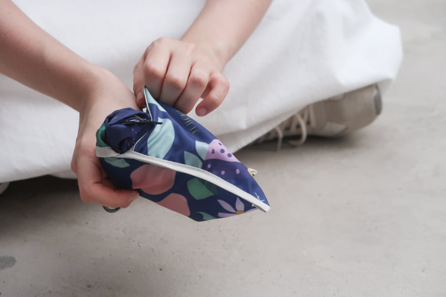 Compact foldable Bible 
verse shopping bag with 
fruit design being secured, 
perfect for Christian gifts 
and easy storage from a 
Christian gift store.