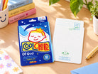 Cool Child of God Fever Patch LOVE SUPERMARKET card showing front and back on a bright wooden desk