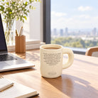 Covenant of Peace ceramic Bible verse mug filled with coffee on a bright wooden desk beside a laptop