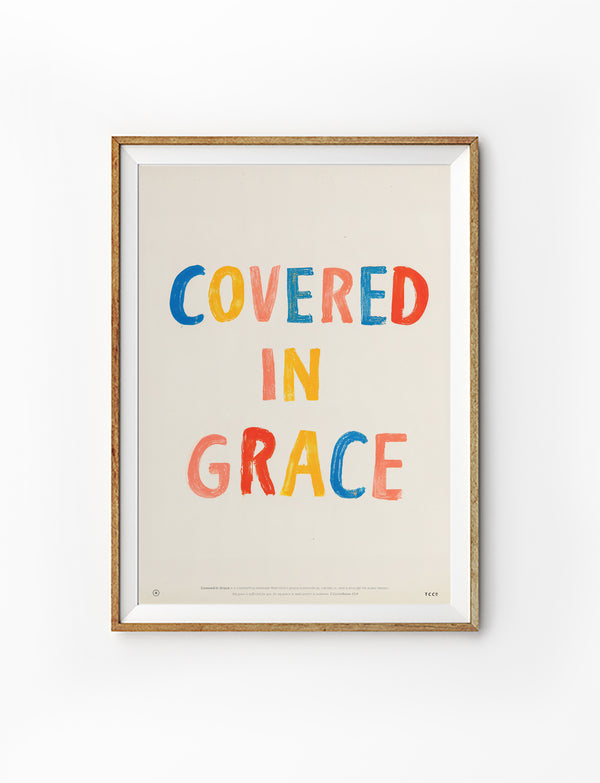 Covered in Grace Christian poster inspired by 2 Corinthians 12:9 in a natural wood frame on a white background