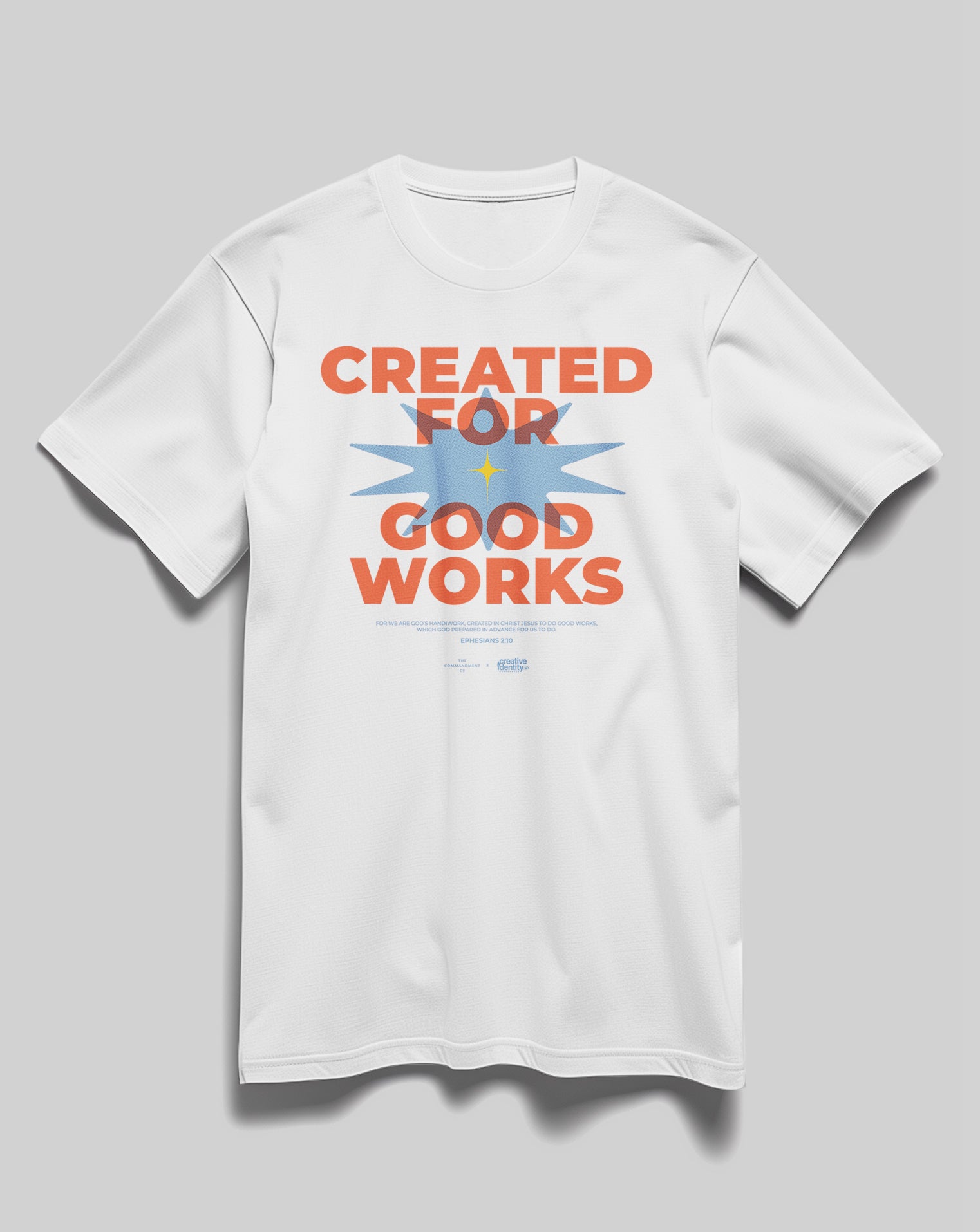 White Christian t-shirt featuring bold orange and blue “Created for Good Works” design, created by The Commandment Co in collaboration with YWAM.
