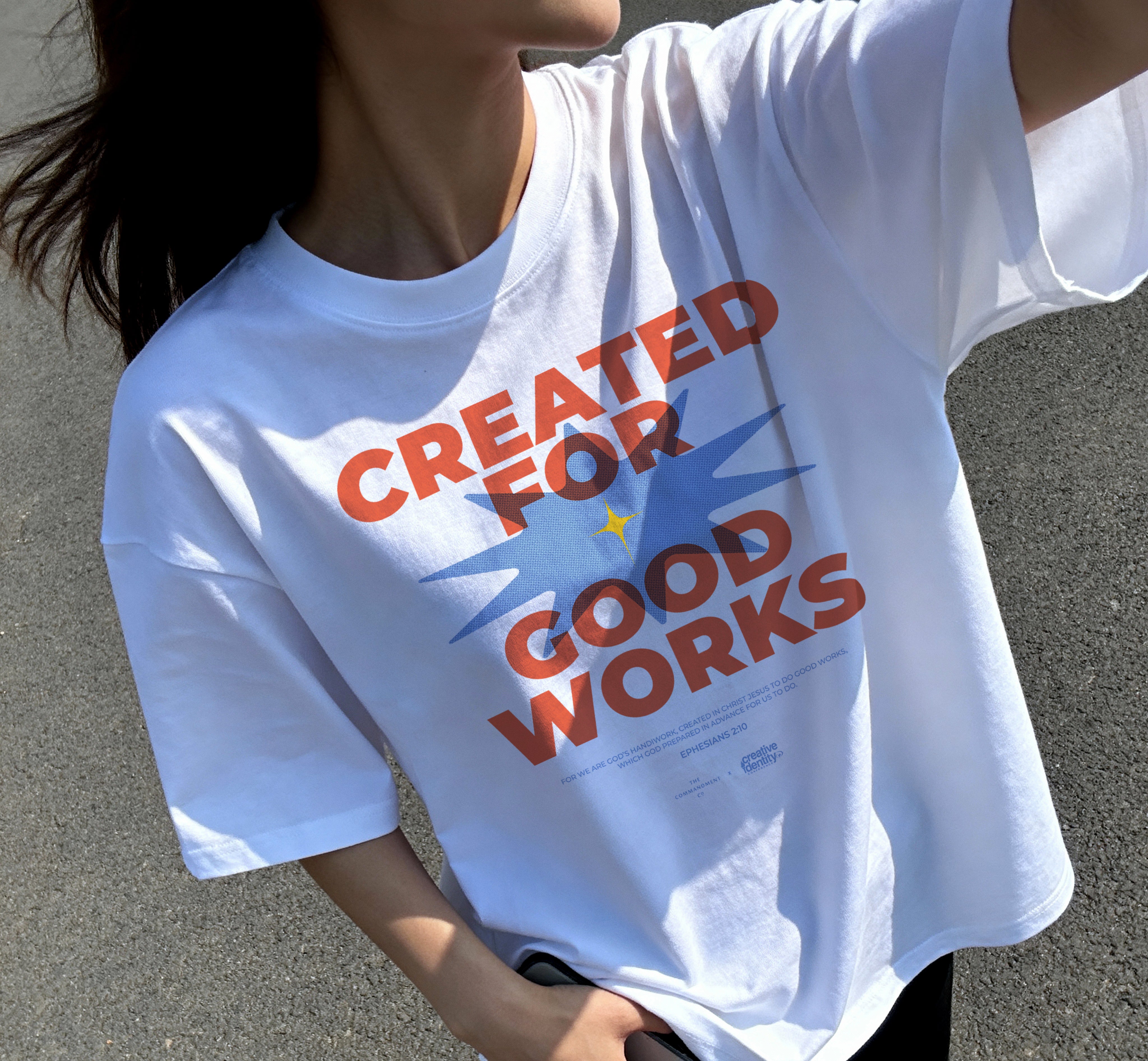 Lifestyle shot of a white oversized “Created for Good Works” Christian t-shirt worn outdoors, featuring a bold faith-based design inspired by Ephesians 2:10.
