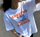 Lifestyle shot of a white oversized “Created for Good Works” Christian t-shirt worn outdoors, featuring a bold faith-based design inspired by Ephesians 2:10.