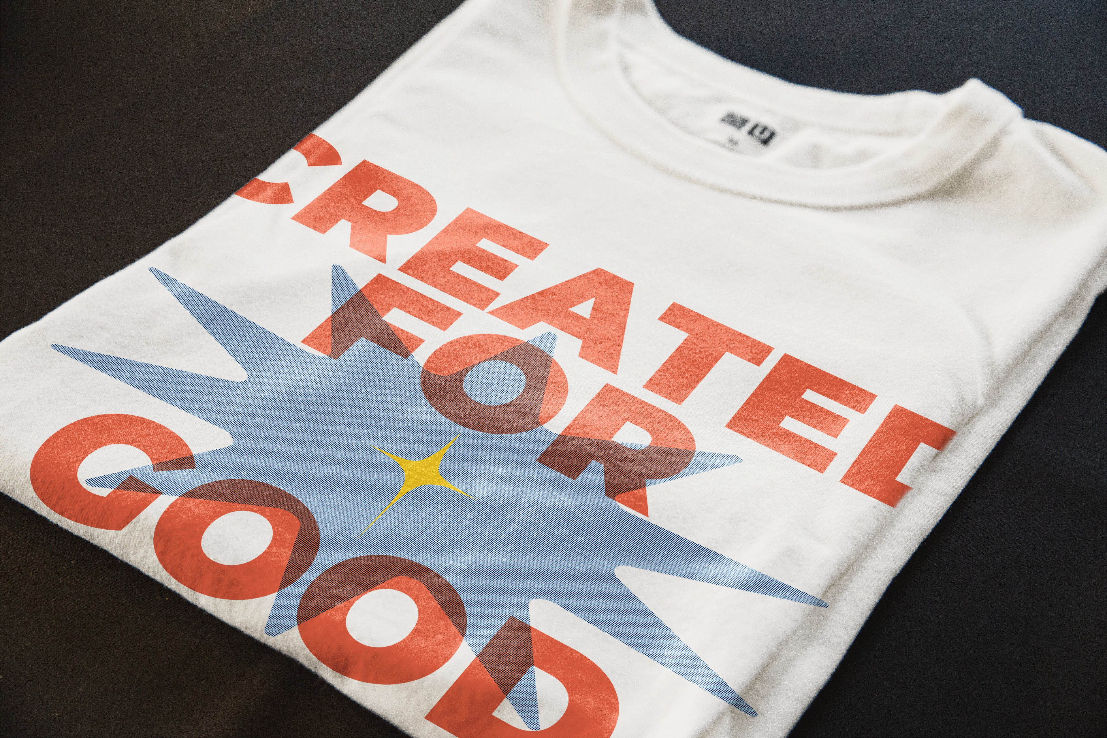 Close-up of the “Created for Good Works” Christian t-shirt print with orange typography, blue graphic detail, and Ephesians 2:10 verse reference.