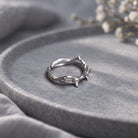 Silver crown of thorns ring styled on a grey stone tray