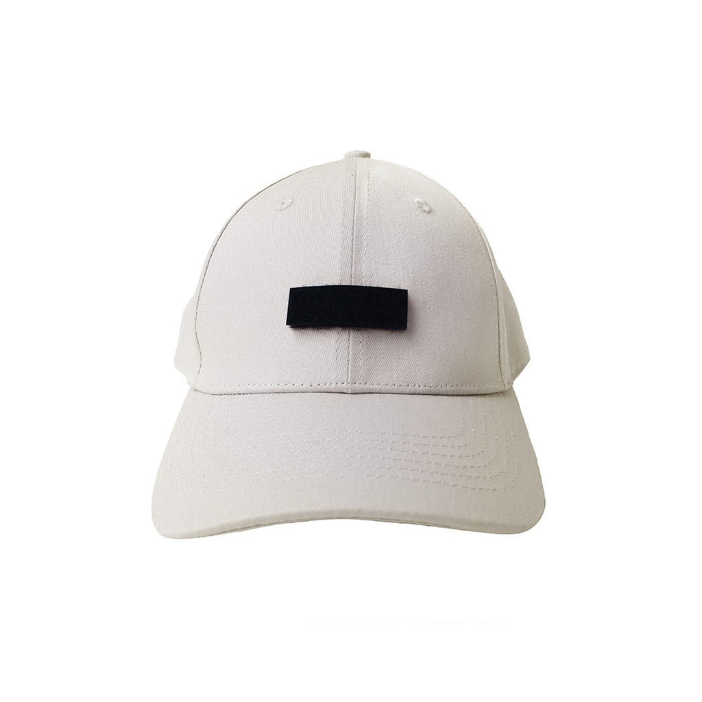 A beige cap featuring a customizable black velcro patch that allows for interchangeable designs, offering a versatile and modern faith-based streetwear accessory.