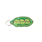 Embroidered keychain with 'Peas Be With You' text and three cute peas.