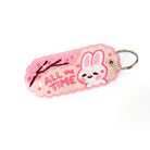 Pink keychain with a happy white bunny and embroidered text 'ALL the TIME'.