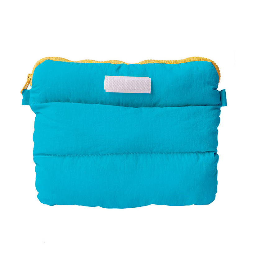 Cyan padded pong pong bag with yellow zipper, ideal for lightweight travel storage.