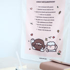 Close-up view of a daily declarations wall tapestry with Bible verses, Christian affirmations, and a cute illustration of Jesus and a sheep.
