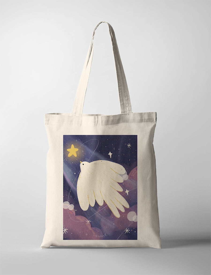 Canvas tote bag with Dita illustration of a white dove flying in a starry night sky holding a glowing star, symbol of peace and hope