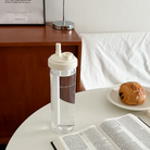 Clear water bottle featuring the message “Enjoy today in the love of God,” shown beside a Bible and breakfast pastry, perfect for daily encouragement and Christian gifting.